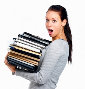 Closeup of a young woman holding a stack of files isolated on wh